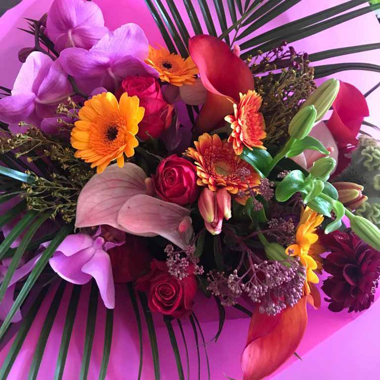 bright floral hand tied with yellow pinks and purples