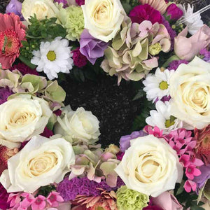 bright floral wreath funeral floral tribute