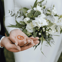 Bride holding wedding flowers featuring roses by Inspired Flowers