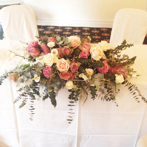 top table arrangement for wedding with eucalyptus and variety of roses - copyright inspired flowers