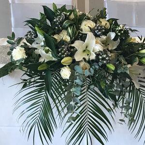 Wedding top table arrangement with plants and lilies - copyright inspired flowers