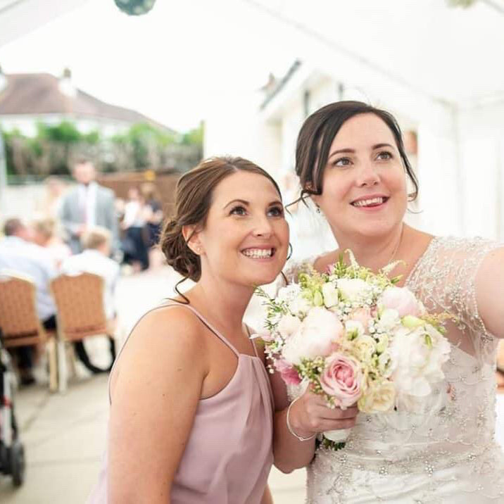 bride and bridesmaid holding bridal floral bouquets