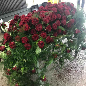 coffin tribute with red roses