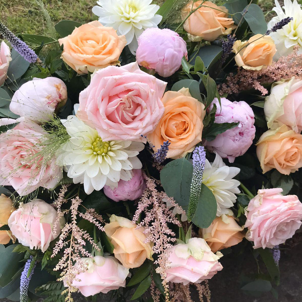 loose tied bridal bouquet in peached and pinks - copyright inspired flowers