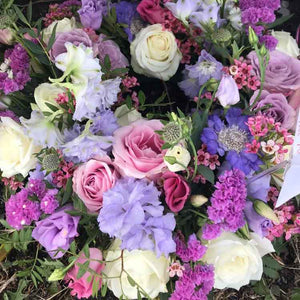 bright summer bouquet with purple and pink roses 