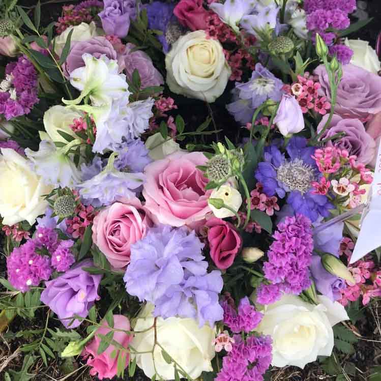 bright summer bouquet with purple and pink roses 