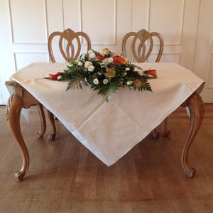 wedding top table arrangement in orange and cream - copyright inspired flowers