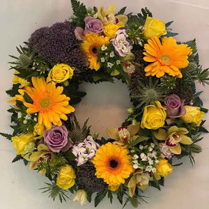 floral funeral wreath with sunflowers and roses