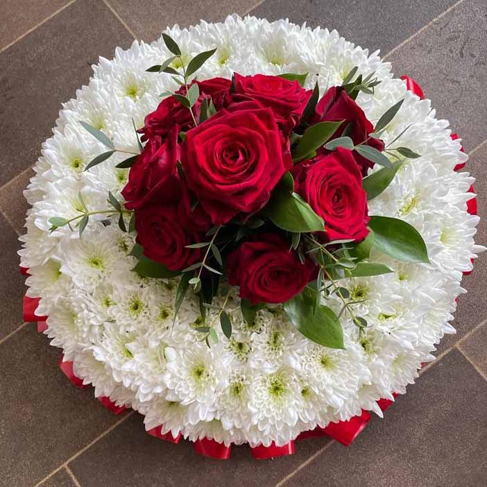 white and red funeral floral tribute