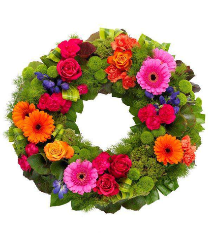 Vibrant Wreath A gloriously vibrant wreath. Cerise and orange Roses and Carnations with orange Germini, purple Anconitum and green spray Chyrsanthemums by Inspired Flowers 