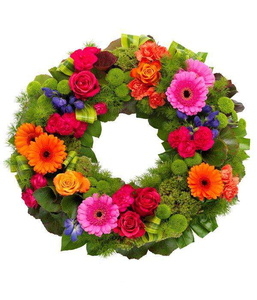 Vibrant Wreath A gloriously vibrant wreath. Cerise and orange Roses and Carnations with orange Germini, purple Anconitum and green spray Chyrsanthemums by Inspired Flowers 