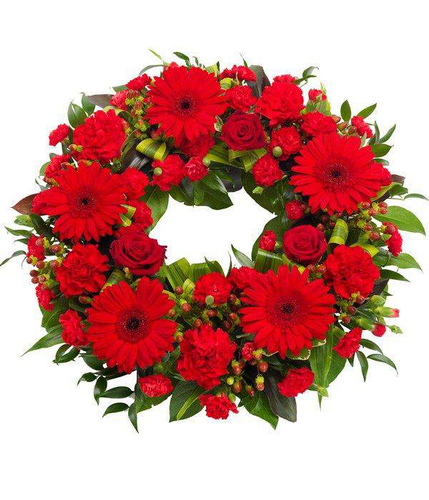 Red Wreath red rose gerbra carnation and hypericum  with luscious green foliage by Inspired Flowers 